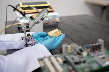 Technicians meticulously repair electronic components to turn them into precious gold. This process...