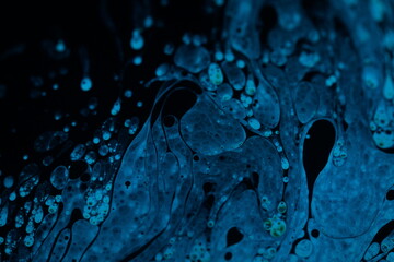 Bright blue particles on black background, oil stains movement, bright chemistry, surreal...