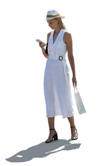 Backlit young confident woman in an elegant white dress and hat standing and looking at her phone isolated on white background