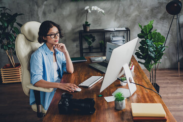 Photo of young woman professional photographer brainstorm use computer loft interior office studio indoors