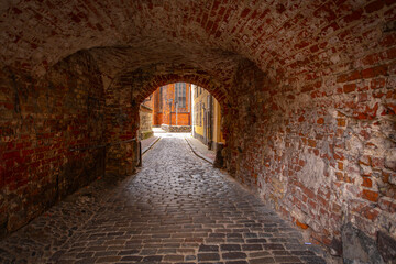 Fototapeta premium Old street in old Riga. The city is capital of Latvia that is well known to be a very popular tourism destination in the Baltic region