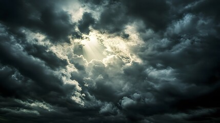 Obraz premium Dark clouds with the sun breaking through, stormy weather, dramatic lighting