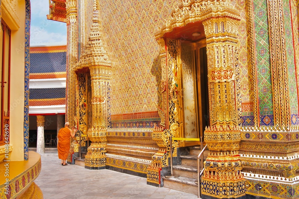 Wall mural a thai monk is walking in a beautiful craftsmanship and famous buddhist temple of wat ratchabophit s