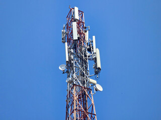 antenna on communication tower on blue sky background