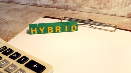 HYBRID technology electric motor business idea Written on wooden cubes for advertising.