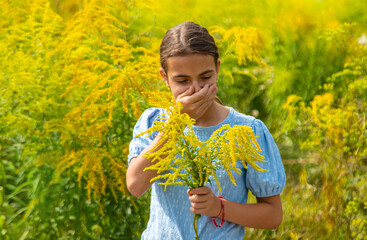 Child in ragweed flowers allergy. Selective focus.