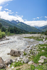 View of mountains and valleys of manali and beas river near Jogini waterfall in Himachal Pradesh India.