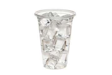 Simple transparent plastic cup with crystal-clear ice cubes isolated on transparent background