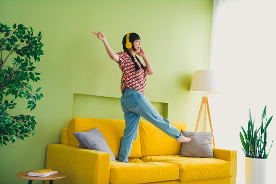 Full size photo of pretty young woman dancing couch weekend modern green yellow interior apartment indoors