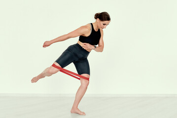 Fitness Trainer Demonstrating Side Leg Lift with Resistance Band