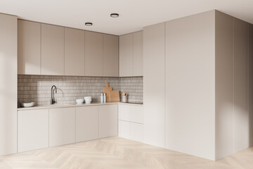 Beige modern home kitchen interior with cooking cabinet and kitchenware