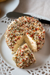 French cheese collection, fresh white soft goat cheese with aromatic herbs, garlic, parsley and red peppers close up