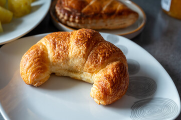Fresh baked two buttered croissants served in restaurant for continental or French breakfast close up