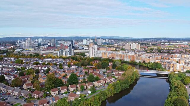 Aerial drone footage of the Grangetown district in Cardiff, Wales with River Taff running through it. Rising push-in shot.