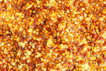 Mustard sauce with grains texture. Yellow Traditional French Mustard sauce as a background. Texture...
