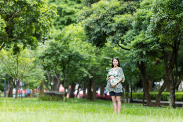 Asian pregnant in the park