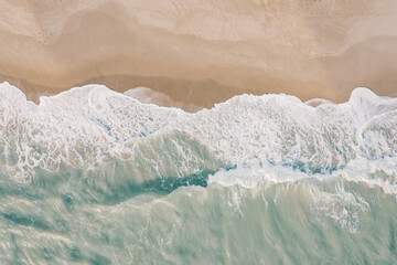 Fototapeta premium Waves Crashing on Sandy Beach