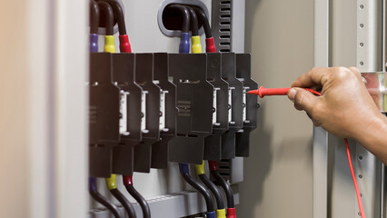 Electrical engineers inspect the operation of electrical control equipment.