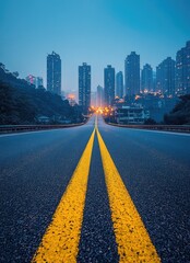 Obraz premium Empty asphalt road leading to a city skyline at dusk.