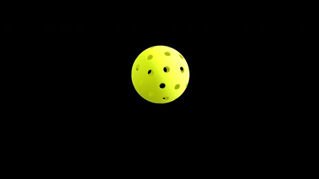 Yellow Pickleball spin with 40 holes on black background
