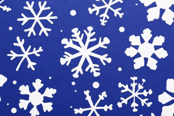 White snowflakes intricately patterned on a vibrant blue background evoke a wintery, festive atmosphere.