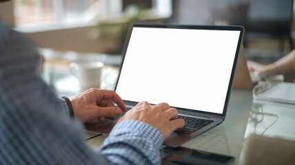 Man Working on Laptop in Cafe with Coffee - Close-Up Views of Hands Typing and Engaging with Laptop on a Wooden Table with Coffee Cup in Modern Coffee Shop