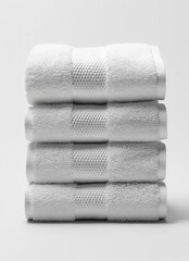 A stack of four white hand towels with a textured pattern.