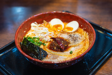 Japanese noodle spicy tonkotsu soup ramen with egg and pork ramen bowl for Japanese food style.