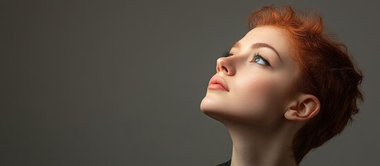 Studio shot portrait of a creative young woman and an inspired photographer envisioning a photography angle against a gray background for copy space