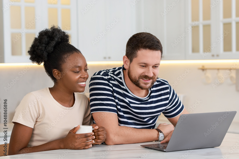 Wall mural international relationships. lovely couple spending time together in kitchen