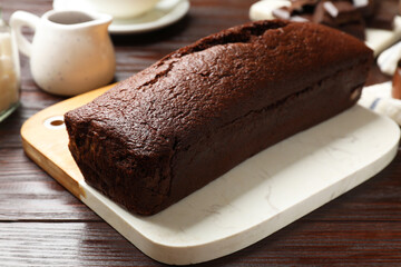 Tasty chocolate sponge cake on wooden table, closeup