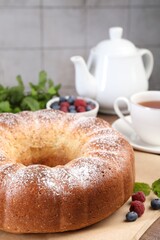 Freshly baked sponge cake and berries on table, closeup