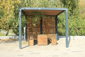A table and benches for relaxing under a canopy. Moscow. Russia.