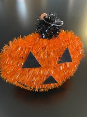 A fluffy looking orange pumpkin Halloween decoration