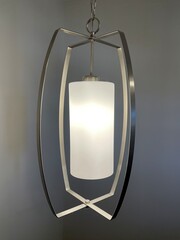 A modern looking hanging ceiling light in nickel finish.