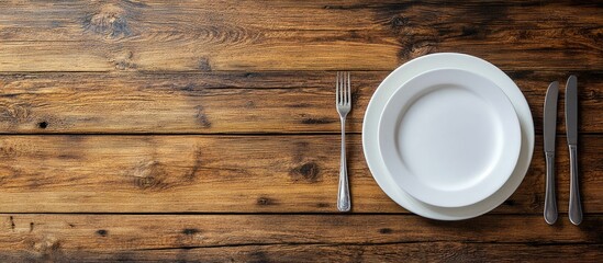 Fork and plates on a wooden table. with copy space image. Place for adding text or design