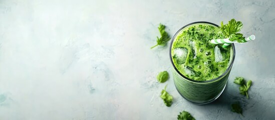 Obraz premium A tall glass filled with a green healthy diet smoothie made from a mix of green vegetables fruits and herbs Copy space Top view