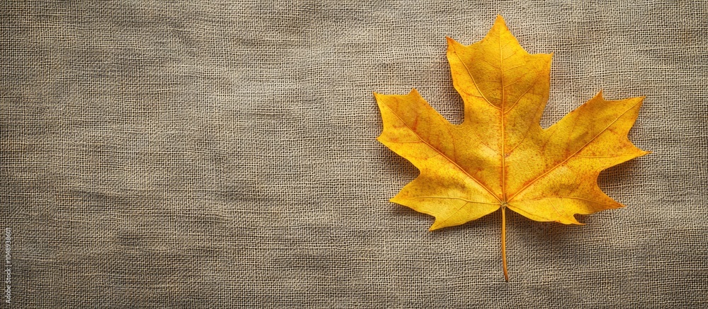Poster Yellow maple leaf on linen canvas Autumn backdrop featuring copyspace