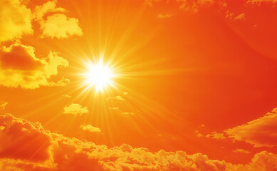 Bright sun shining through clouds in orange sky