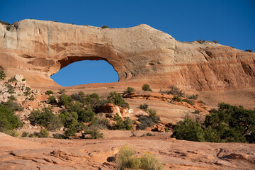 an amazing huge rock arch rock formation of red, brown, and yellow rock hematite, iron oxide in...