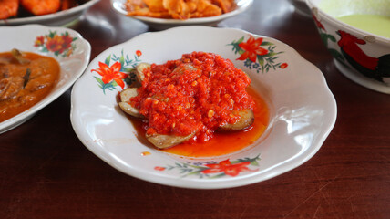 Jengkol Balado on a white plate. Jengkol or Archidendron pauciflorum or Dogfruit.