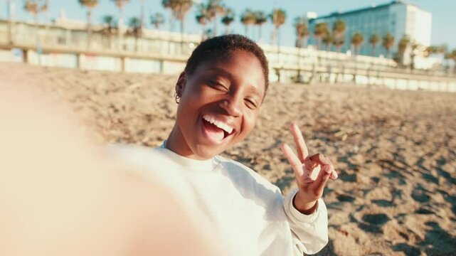 Close-up of a girl taking selfies on the beach on a sunny summer day