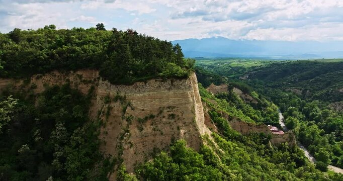 Soil Erosion Cliffs Vibrant Landscape Sunny Day Aerial Orbit Descend