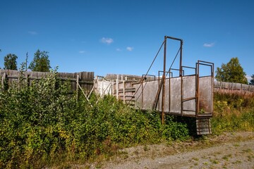 Abandoned loading ramp rusting in overgrown field in Norway
