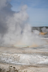 an active geyser spring with an intermittent discharge of water ejected turbulently and accompanied by steam
