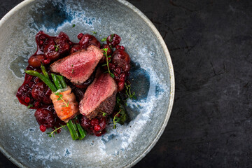 Traditionally roasted fillet of saddle of venison with chestnuts, bacon-wrapped bean sticks and...