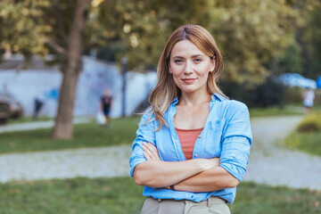 Confident Woman Standing Outdoors in a Park Setting