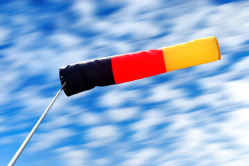 german windsock and clouds motion blur