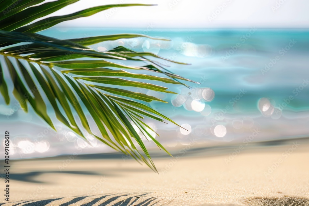 Poster palm tree leaf is laying on the sand next to the ocean. the image has a serene and peaceful mood, wi