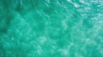 Fototapeta premium An inviting scene of shimmering turquoise ocean waters under the bright sunlight, evoking a sense of calm, freedom, and the refreshing spirit of nature.